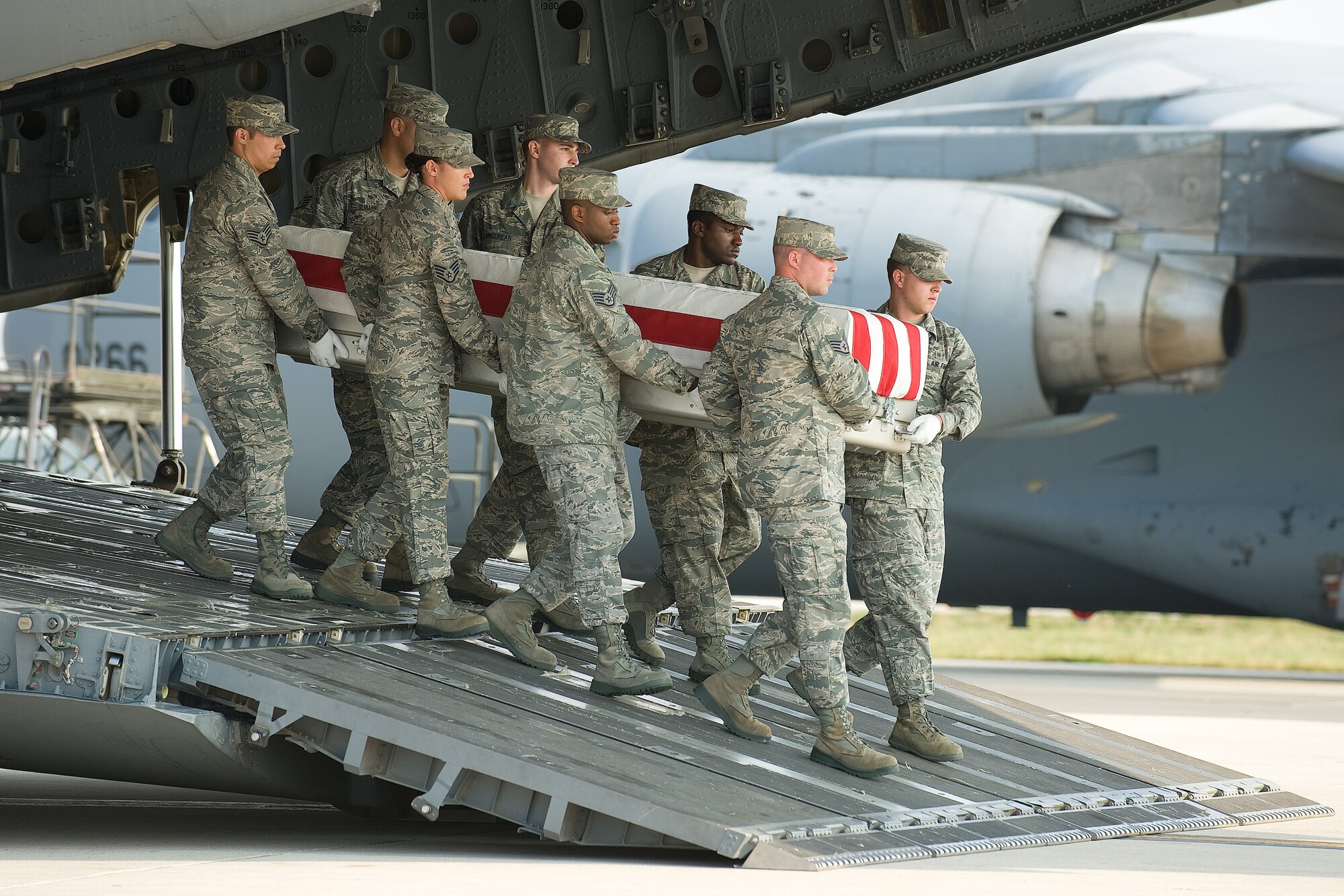 A U.S. Air Force carry team transfers the remains of Air Force Senior Airman Michael J. Buras of Fitzgerald, Ga., at Dover Air Force Base, Del., Sept 23, 2010. Buras was assigned to the 99th Civil Engineer Squadron, Nellis Air Force Base, Nev. (U.S. Air Force photo/Jason Minto)