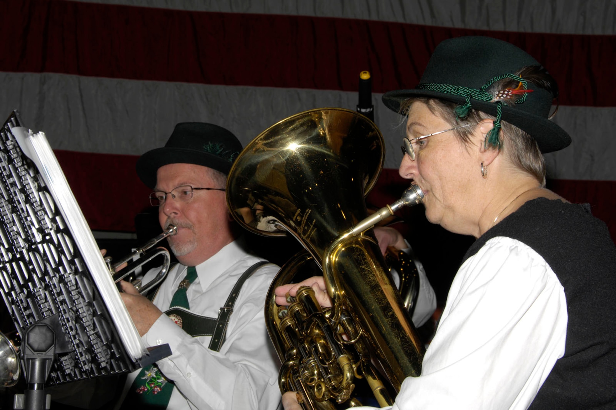 HANSCOM AIR FORCE BASE, Mass. – Two members of the Mad Bavarian Brass Band play their instruments during Oktoberfest in the Aero Club Hangar on Oct. 1. Oktoberfest featured German-themed food such as bratwursts and sauerkraut, the Mad Bavarian Brass Band that played German-style music, pumpkin decorating, vendors and games and activities for kids. (U.S. Air Force photo by Linda LaBonte Britt) 