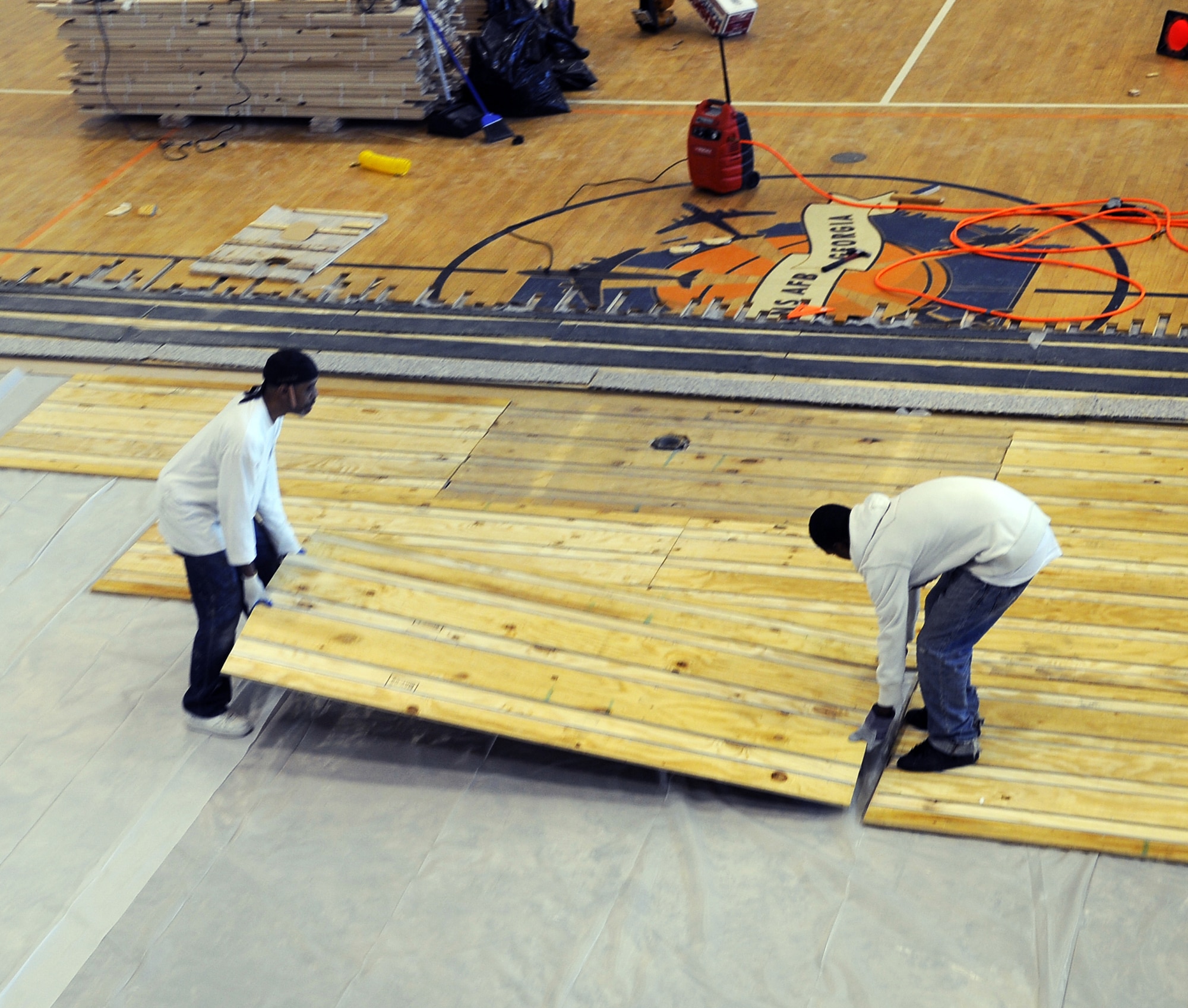 CBA Sports employees work on the subfloor of the gym at the fitness center. U. S. Air Force photo by Sue Sapp
