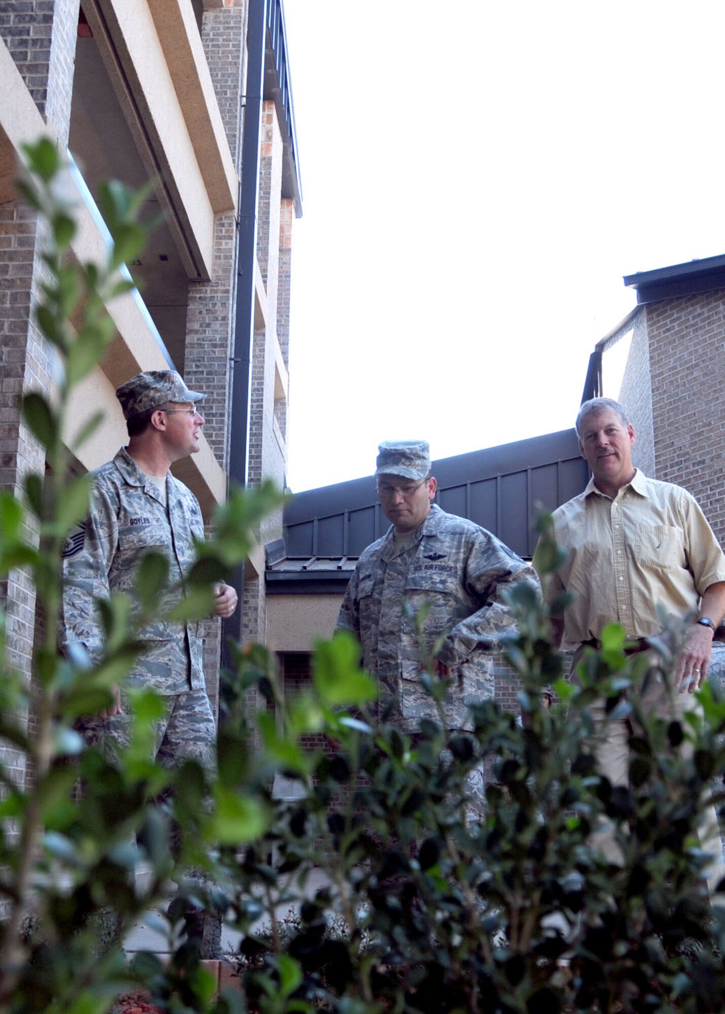 ALTUS AIR FORCE BASE, Okla. -- Senior Master Sgt. Richard Boyles, 97th Logistics Readiness Group first sergeant, Tech. Sgt. Joe Villanueva, dormitory manager, and Mr. Thomas Donovan, dormitory manager, with the new landscaping at dorm 331. Members of the 97th Civil Engineer Squadron were key players in the renovation, providing tools, materials, resource and manpower as well as expert advisors.(U.S. Air Force photo by Tech. Sgt. Jennifer D. Seidl / Released 97th Air Mobility Wing Public Affairs)