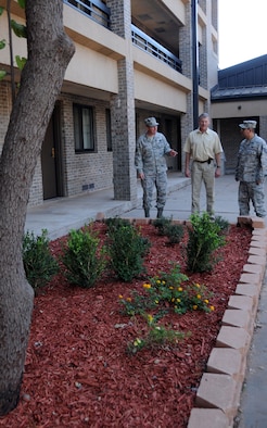 ALTUS AIR FORCE BASE, Okla. -- Senior Master Sgt. Richard Boyles, 97th Logistics Readiness Group first sergeant, Mr. Thomas Donovan, dormitory manager, and Tech. Sgt. Joe Villanueva, dormitory manager, admire the work done by Airmen volunteers. 32 volunteers gathered Sept. 30 to renovate the landscaping at dorm 331.  (U.S. Air Force photo by Tech. Sgt. Jennifer D. Seidl / Released 97th Air Mobility Wing Public Affairs)