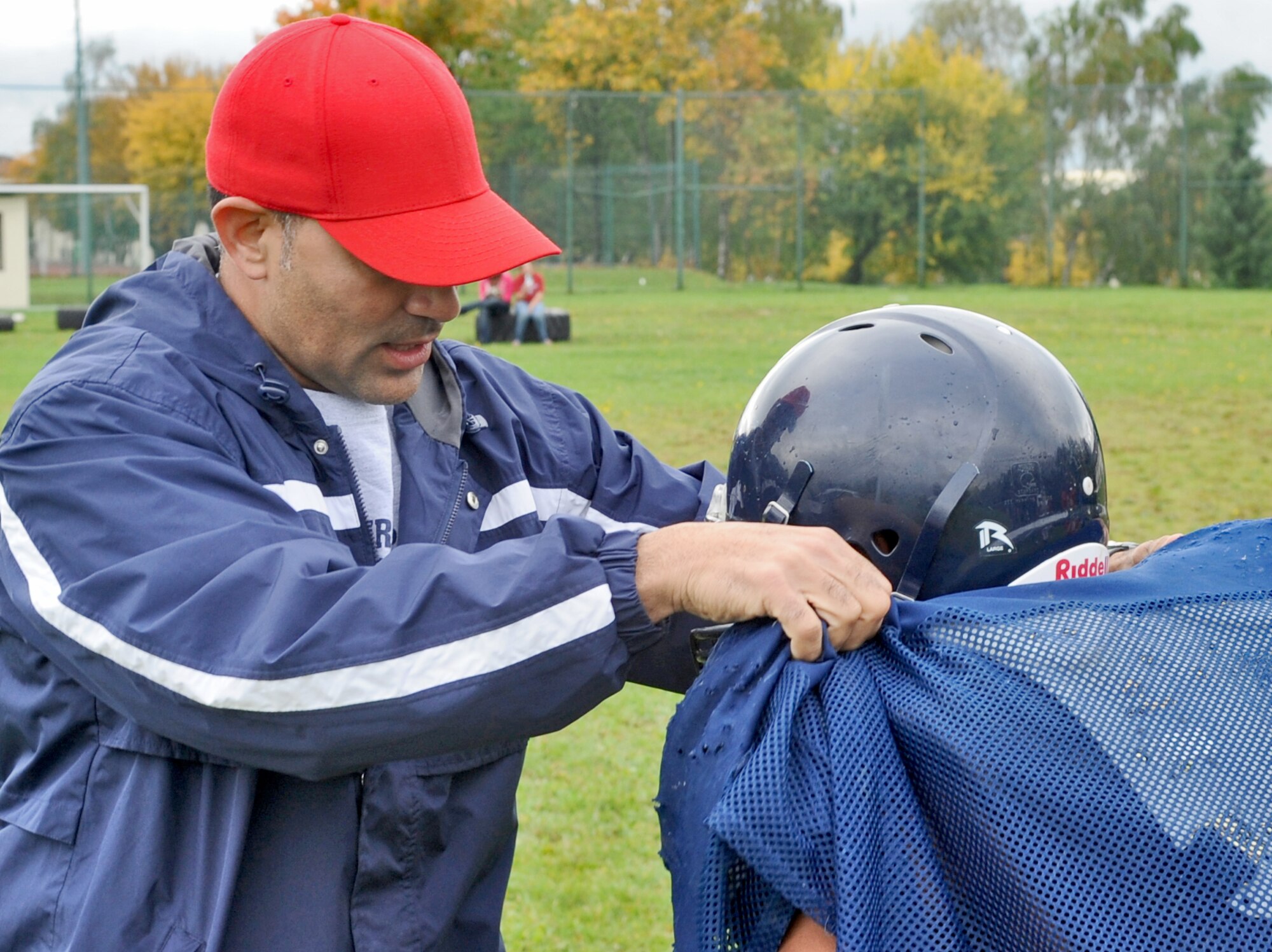 SPANGDAHLEM AIR BASE, Germany – Tech. Sgt. Erick Matos, 52nd Operations Support Squadron and a coaching staff member for the Bitburg High School Baron football team, shows Derrick Bland, BHS junior, how to block a defender Oct. 5. Sergeant Matos currently volunteers approximately 15 hours a week to help his 17 year-old-son’s high school football team. (U.S. Air Force photo/Senior Airman Nick Wilson)