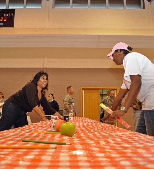 RAF MILDENHALL, England -- Brenda Rodriguez, wife of Master Sgt. Robert Rodriguez, 67th Special Operations Squadron, and Staff Sgt. Clarice Brown, 352nd Special Operations Support Squadron, decorate tables with a back-to-school theme for a Hearts Apart dinner, Aug. 26, 2010. Over 20 families attended the dinner sponsored by the Airman and Family Readiness Center for family members of active duty personnel who are deployed.  (U.S. Air Force photo/Tech. Sgt. Marelise Wood)