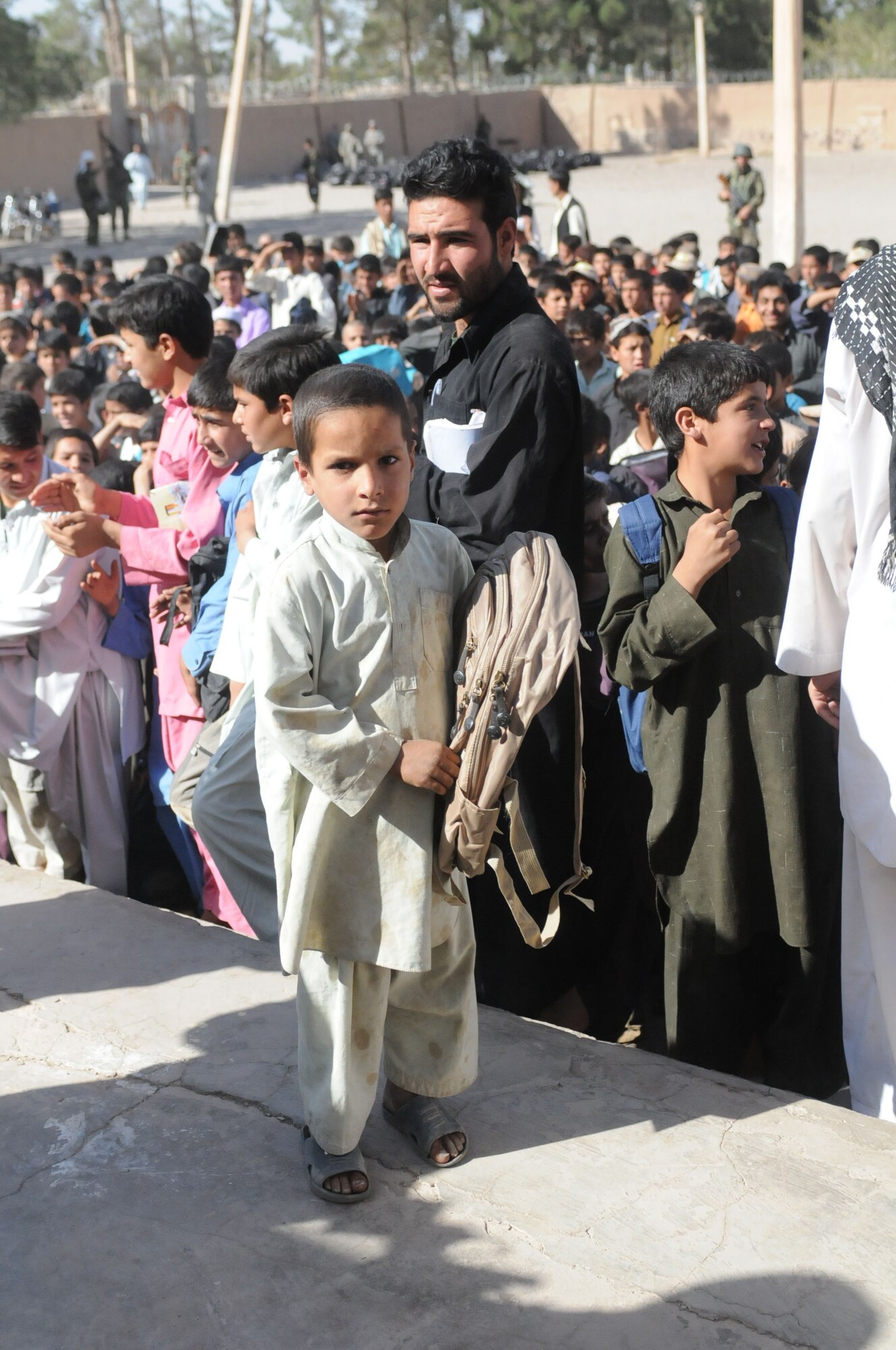 Shindand, Afghanistan – Local boy after receiving his new backpack from soldiers and airman from Shindand Air base and the local Afghan soldiers and airman. Many children in this area are not used to receiving much and overjoyed to be getting, in many cases, their first backpack. (U.S. Navy photo by Mass Communication Specialist 3rd Class Jared E. Walker/ RELEASED).