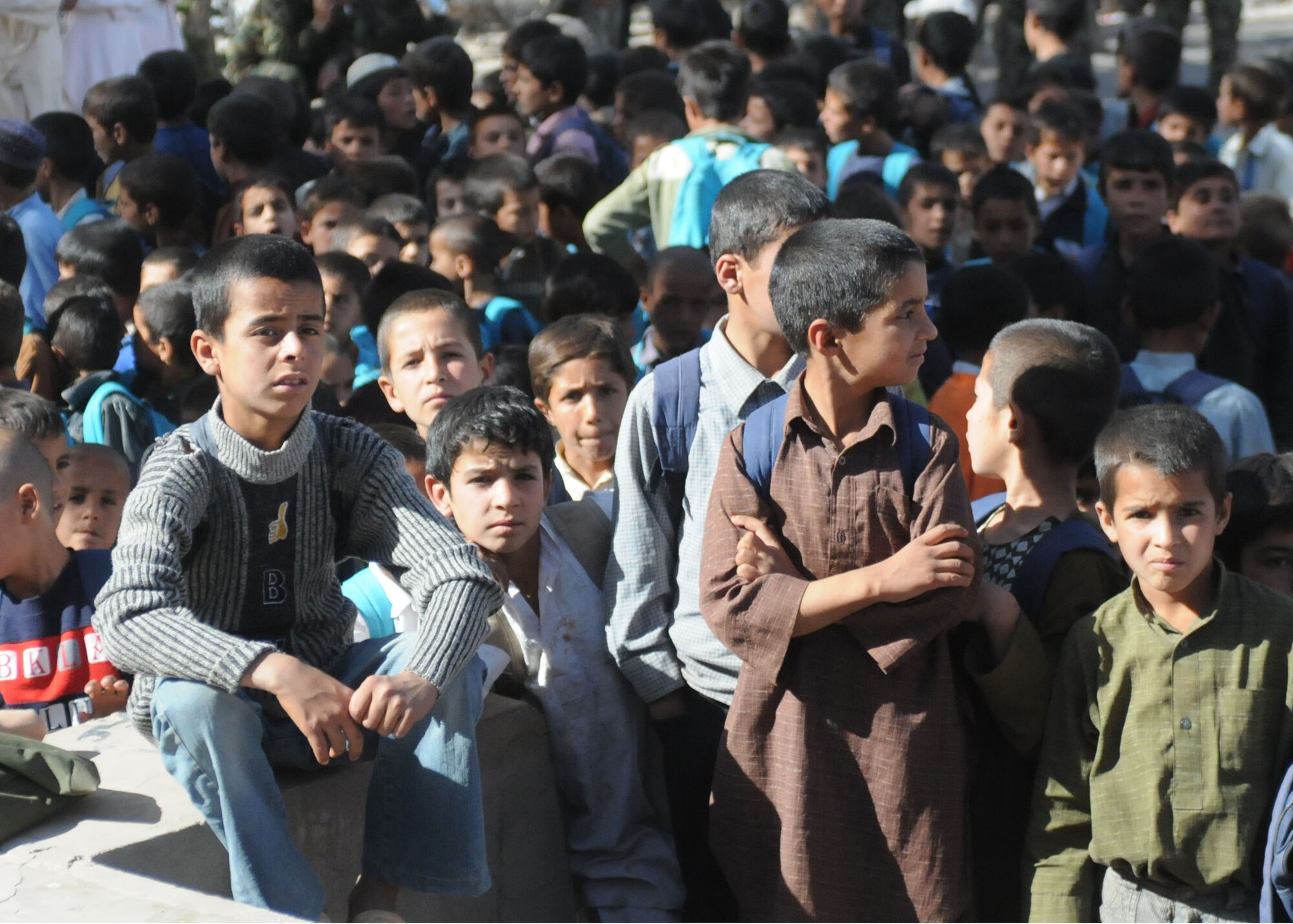 Boys that attend the local boys school near Air Base Shindand listen to Maj. Gen. Shadzada and the headmaster of the boys school before receiving their new backpacks and school supplies.  2,000 backpacks were delivered to the boys’ school.  Also donated to the school were plenty of soccer balls for them to play with as well. (U.S. Navy photo by Mass Communication Specialist 3rd Class Jared E. Walker/ RELEASED).