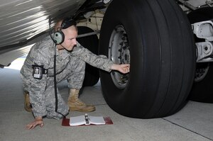 Senior Airman Michael Barrett from the 437th Aircraft Maintenance Squadron onboard Join Base Charleston-Air Base, checks the tire air pressure on a Charleston C-17 aircraft as part of the inspection prior to maintenance being performed Oct. 5. Upon arrival of an aircraft, a thorough inspection is conducted to ensure that the equipment on the aircraft is up-to-date on its maintenance unless they are otherwise previously scheduled for maintenance. (U.S. Navy photo/Mass Communication Specialist 1st Class Jennifer Hudson)