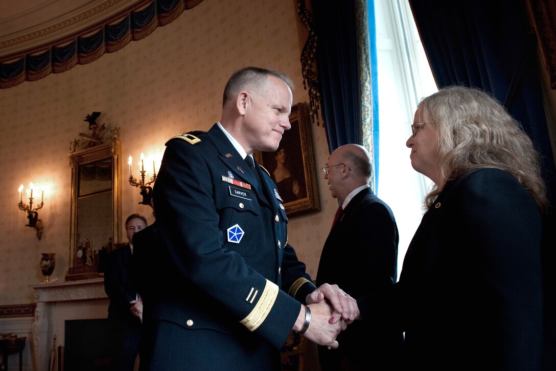 Army Chief of Chaplains Maj. Gen. Douglas Carver speaks with Maureen Miller, the mother of U.S. Army Staff Sgt. Robert J. Miller, after a Medal of Honor ceremony for her son at the White House, Oct. 6, 2010.
