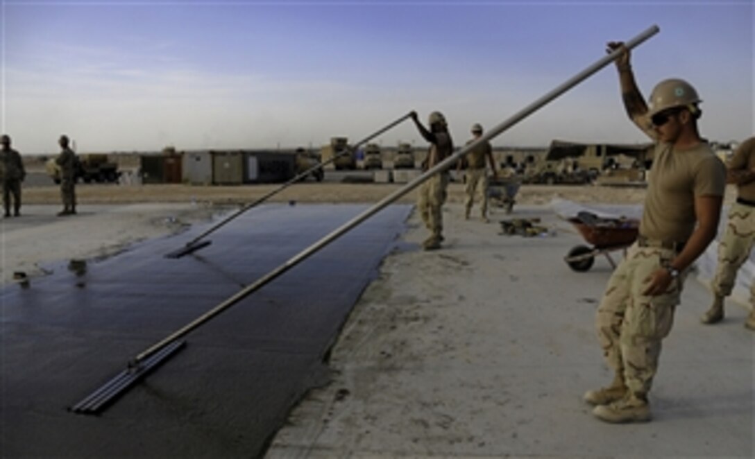 U.S. Navy Seabees with Naval Mobile Construction Battalion 40 lay concrete for a project at Camp Deh Dadi II in northern Afghanistan on Sept. 25, 2010.  