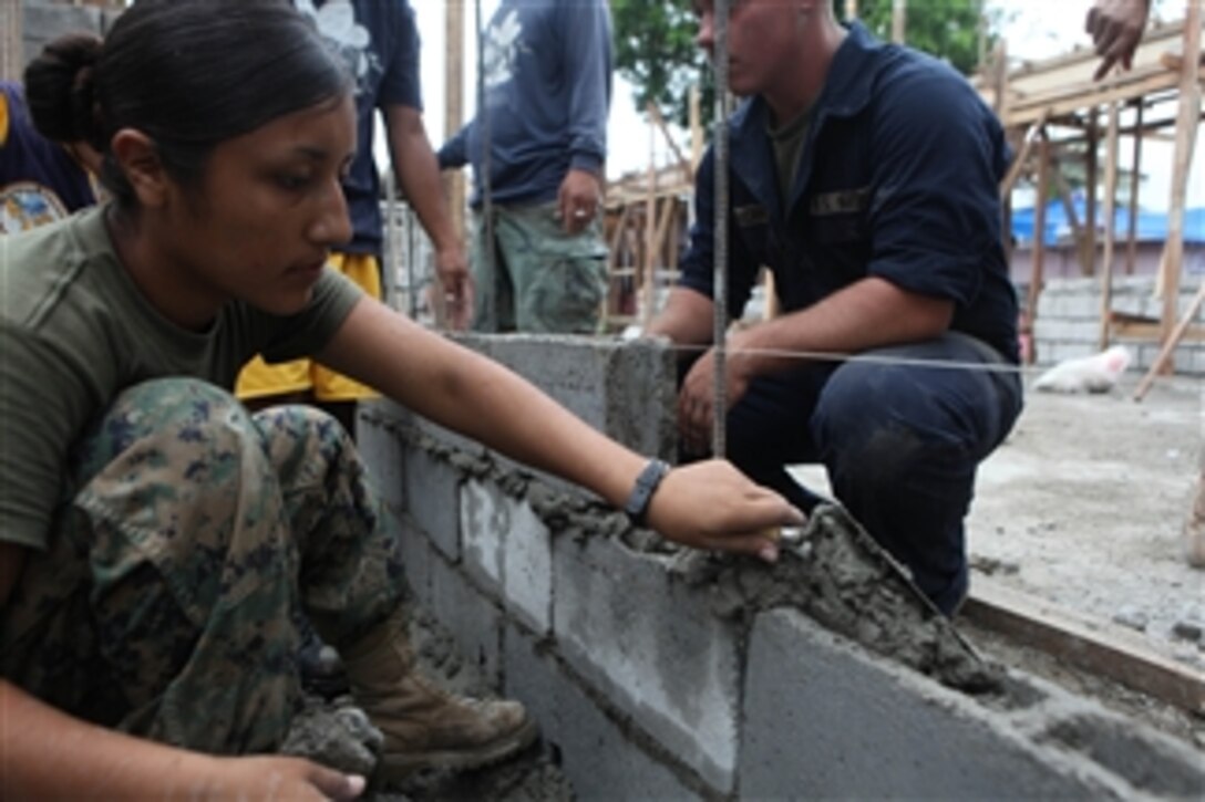 U.S. Marine Corps Lance Cpl. Diana Ceja (left), a combat engineer with Combat Logistics Battalion 31, 31st Marine Expeditionary Unit, lays mortar during the construction of new classrooms at the Anastacio N.F. Dinglas Elementary School in Ternate, Philippines, during Amphibious Landing Exercise FY 2011.  The exercise is a bilateral training exercise and security assistance program between the U.S. military and the Armed Forces of the Philippines.  