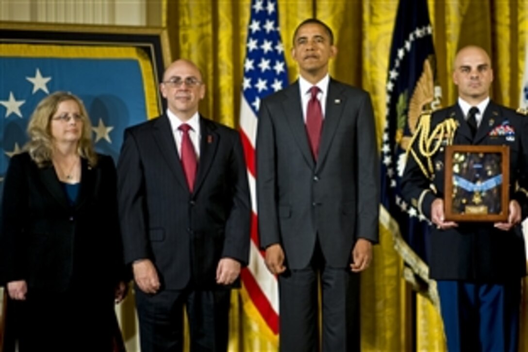 President Barack Obama presents the Medal of Honor posthumously to Phil and Maureen Miller, the parents of U.S. Army Staff Sgt. Robert J. Miller, during a ceremony in the East Room of the White House in Washington, D.C., Oct. 6, 2010. Miller received the honor for heroic actions in Afghanistan, Jan. 25, 2008, after sacrificing his life to save the lives of his teammates and 15 Afghanistan soldiers.