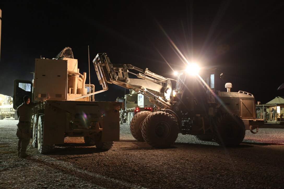 Marines with Transportation Support Compnay B, Combat Logistics Battalion 5, 1st Marine Logistics Group (Forward), load essential cargo on several vehicles during a resupply mission to Forward Operating Base Marjah, Oct. 10.