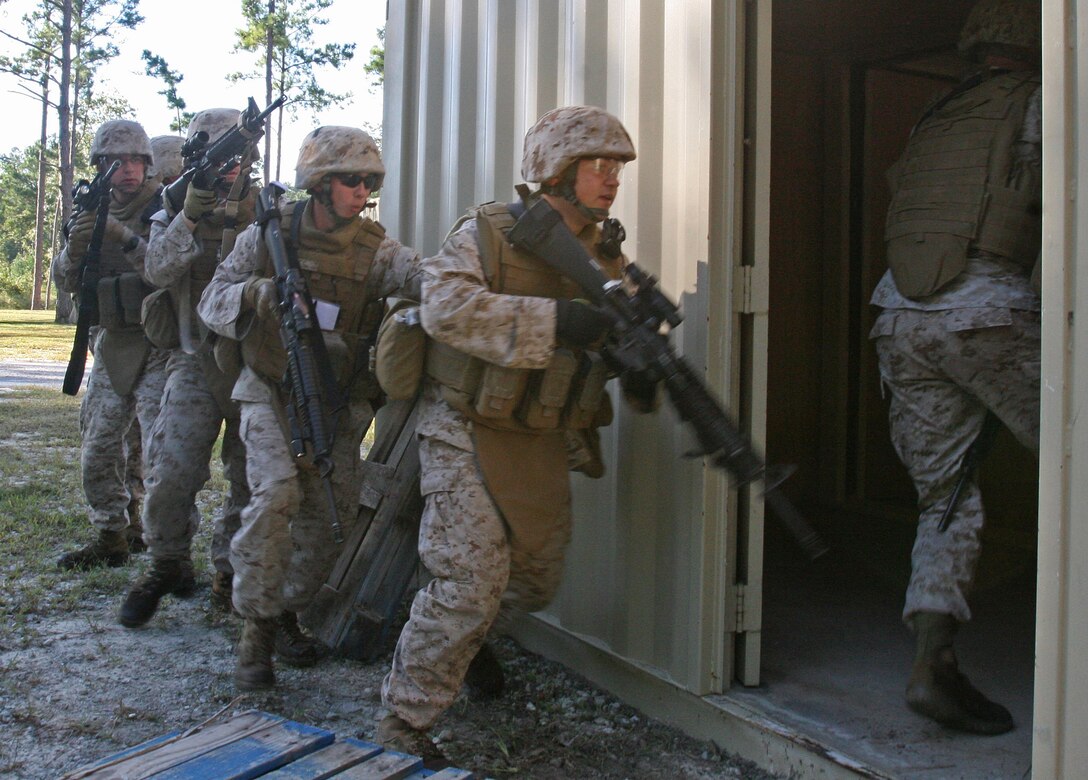 Marines of General Support Platoon, Military Police Support Company, II Marine Expeditionary Force Headquarters Group, breach and enter a house during a movement on urban terrain exercise aboard Marine Corps Base Camp Lejeune, N.C., Oct. 7, 2010. The primary focus of the exercise was to test the Marines’ MOUT capabilities, with an emphasis on tactical site exploitation.