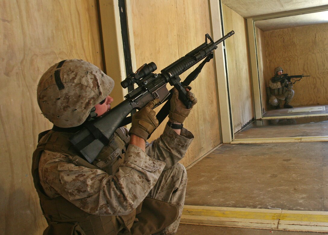 Corporal Garrett Haynes of General Support Platoon, Military Police Support Company, II Marine Expeditionary Force Headquarters Group, scans the floor above for possible simulated insurgents during a movement on urban terrain exercise aboard Marine Corps Base Camp Lejeune, N.C., Oct. 7, 2010. The primary focus of the exercise was to test the Marines’ MOUT capabilities, with an emphasis on tactical site exploitation.