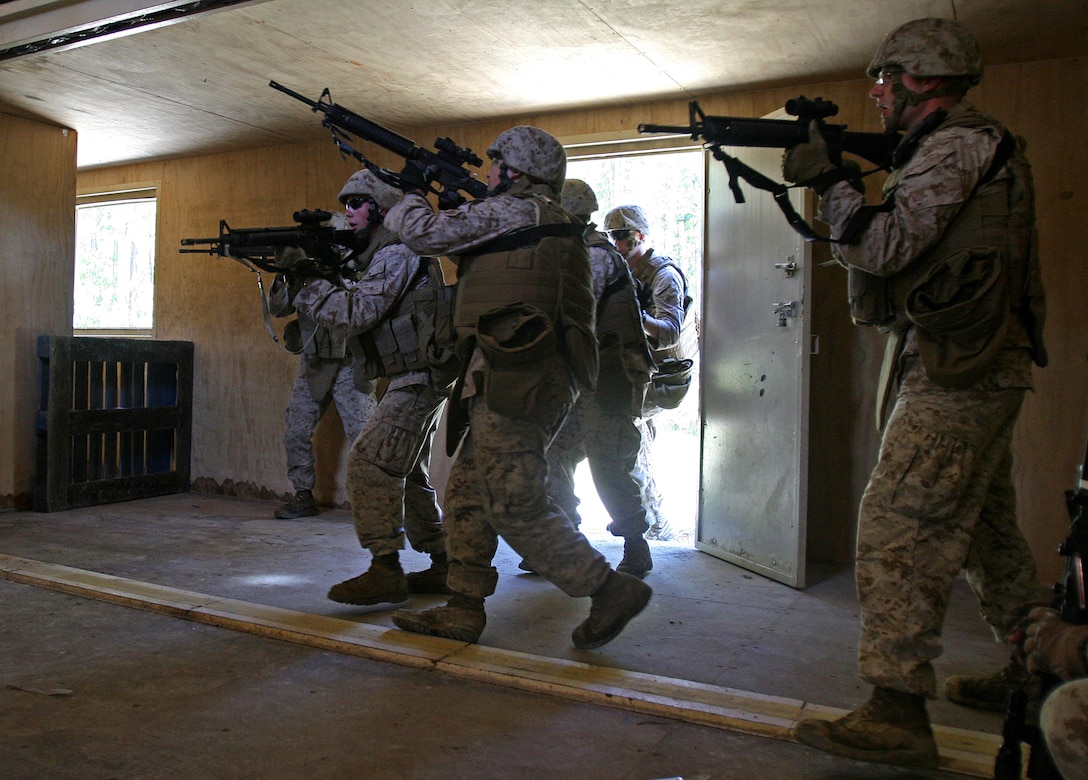 Marines with General Support Platoon, Military Support Company, II Marine Expeditionary Force Headquarters Group, breach and clear a house during a movement on urban terrain exercise aboard Marine Corps Base Camp Lejeune, N.C., Oct. 7, 2010. The primary focus of the exercise was to test the Marines’ MOUT capabilities, with an emphasis on tactical site exploitation.