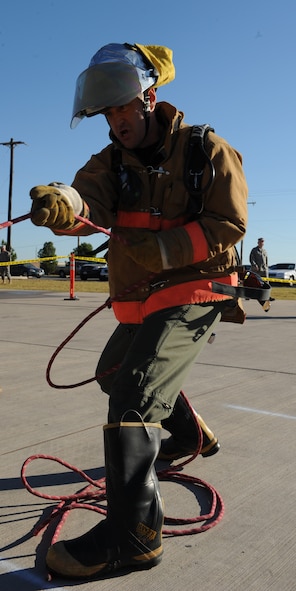 DYESS AIR FORCE BASE, Texas—Col. David Beén, 7th Bomb Wing commander, pulls on a rope during a Firefighters Challenge here, Oct. 8. Firefighters from the 7CES hosted an obstacle course challenge for Dyess Airmen as their final Fire Prevention Week event.  More than 40 teams participated in the event that consisted of six obstacles such as putting on bunker gear, carrying a fire hose up l)a flight of stairs and carrying a 175 pound dummy. (U.S Air Force photo/ Airman 1st Class Shannon Hall)