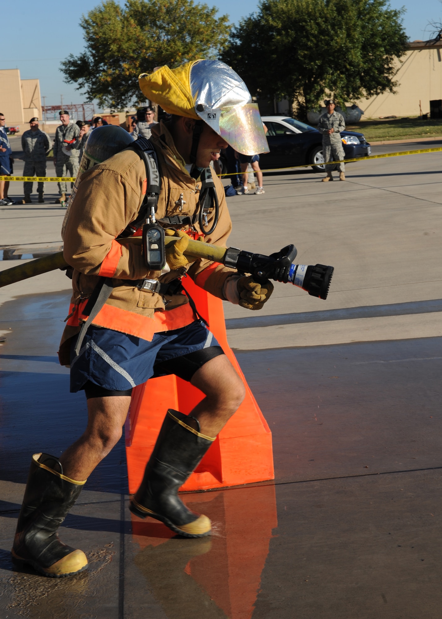 DYESS AIR FORCE BASE, Texas—Airman 1st Class Javier Hernandez, 7th Civil Engineer Squadron, prepares to shoot water out of a fire hose during a Firefighters Challenge here, Oct. 8. Firefighters from the 7 CES hosted an obstacle course challenge for Dyess Airmen as their final Fire Prevention Week event.  More than 40 teams participated in the event that consisted of six obstacles such as putting on bunker gear, carrying a fire hose up a flight of stairs and carrying a 175 pound dummy. (U.S Air Force photo/ Airman 1st Class Shannon Hall)