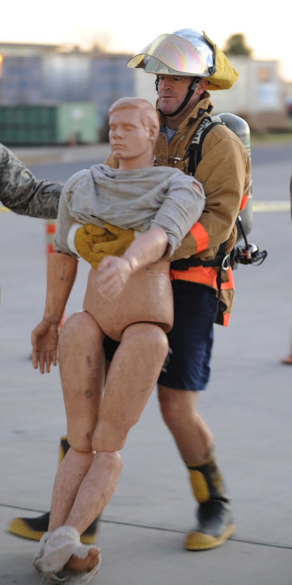 DYESS AIR FORCE BASE, Texas—Lt. Col. John Tryon, 7th Civil Engineer Squadron commander, carries a dummy during a Firefighters Challenge here, Oct. 8. Firefighters from the 7 CES hosted an obstacle course challenge for Dyess Airmen as their final Fire Prevention Week event.  More than 40 teams participated in the event that consisted of six obstacles such as putting on bunker gear, carrying a fire hose up a flight of stairs and carrying a 175 pound dummy. (U.S Air Force photo/ Airman 1st Class Shannon Hall) 