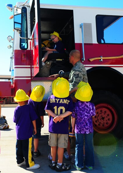 DYESS AIR FORCE BASE, Texas--Tech. Sgt. Garey Schmidt, 7th Civil Engineer Squadron firefighter, shows Merkel Elementary students a firetruck at the Fire Department here Oct. 8. Firefighters from the 7 CES gave kindergarteners from Merkel Elementary a tour of the fire department. Students also were given demonstrations by the dog handlers at the K-9 unit. Dyess hosts tours throughout the year that are open to the public. For more information on tours call the Public Affairs office at (325) 696-4820. (U.S. Air Force photo/Airman 1st Class Chelsea Cummings)