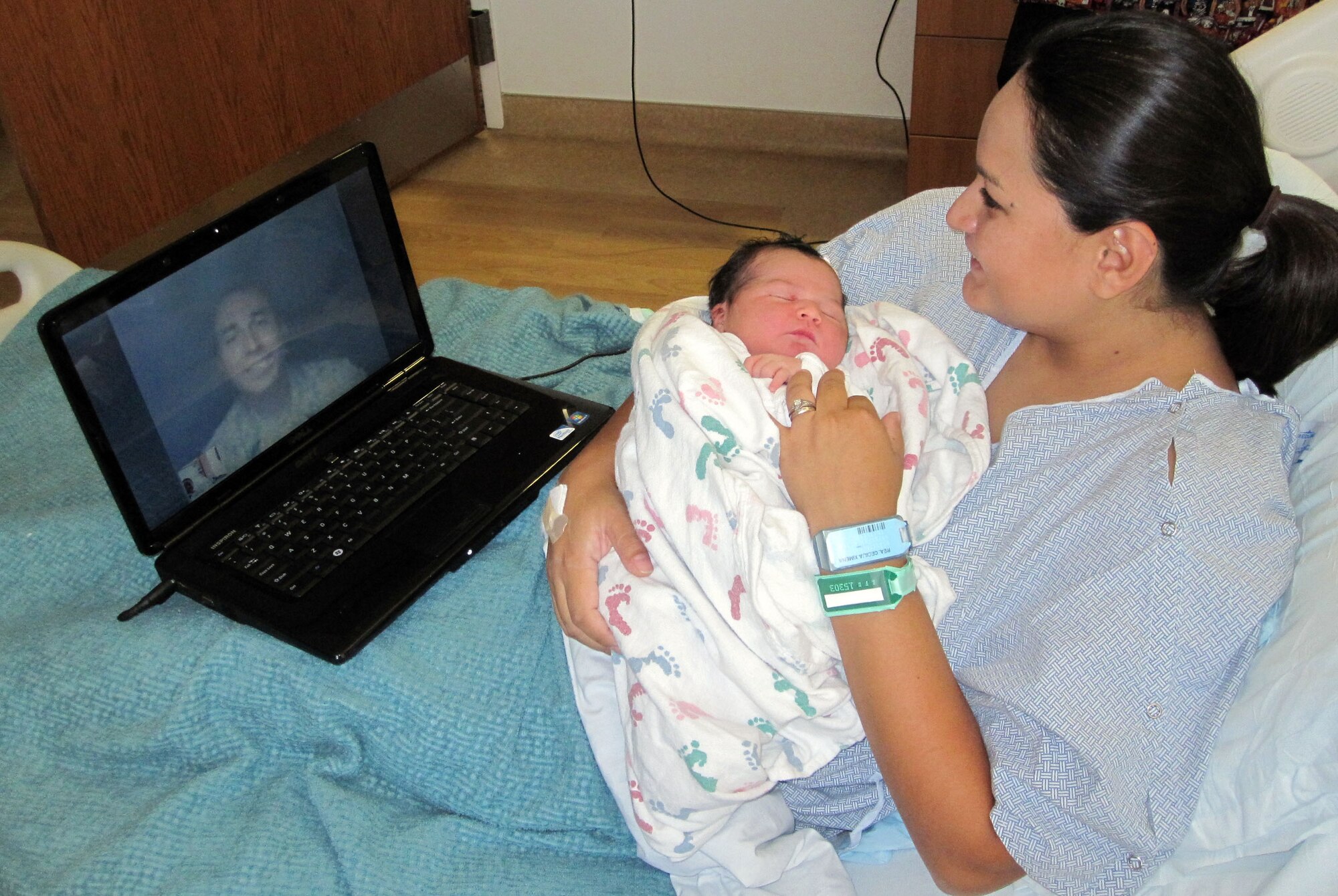 Cecilia Rea uses Skype to talk to her husband, Senior Airman Geiber Rea of the 419th Civil Engineer Squadron, who is currently deployed to Bagram Airfield, Afghanistan. Thanks to technology, the Reas shared the entire delivery-room experience together, despite Airman Rea being halfway around the world. (U.S. Air Force photo/Bryan Magaña)
