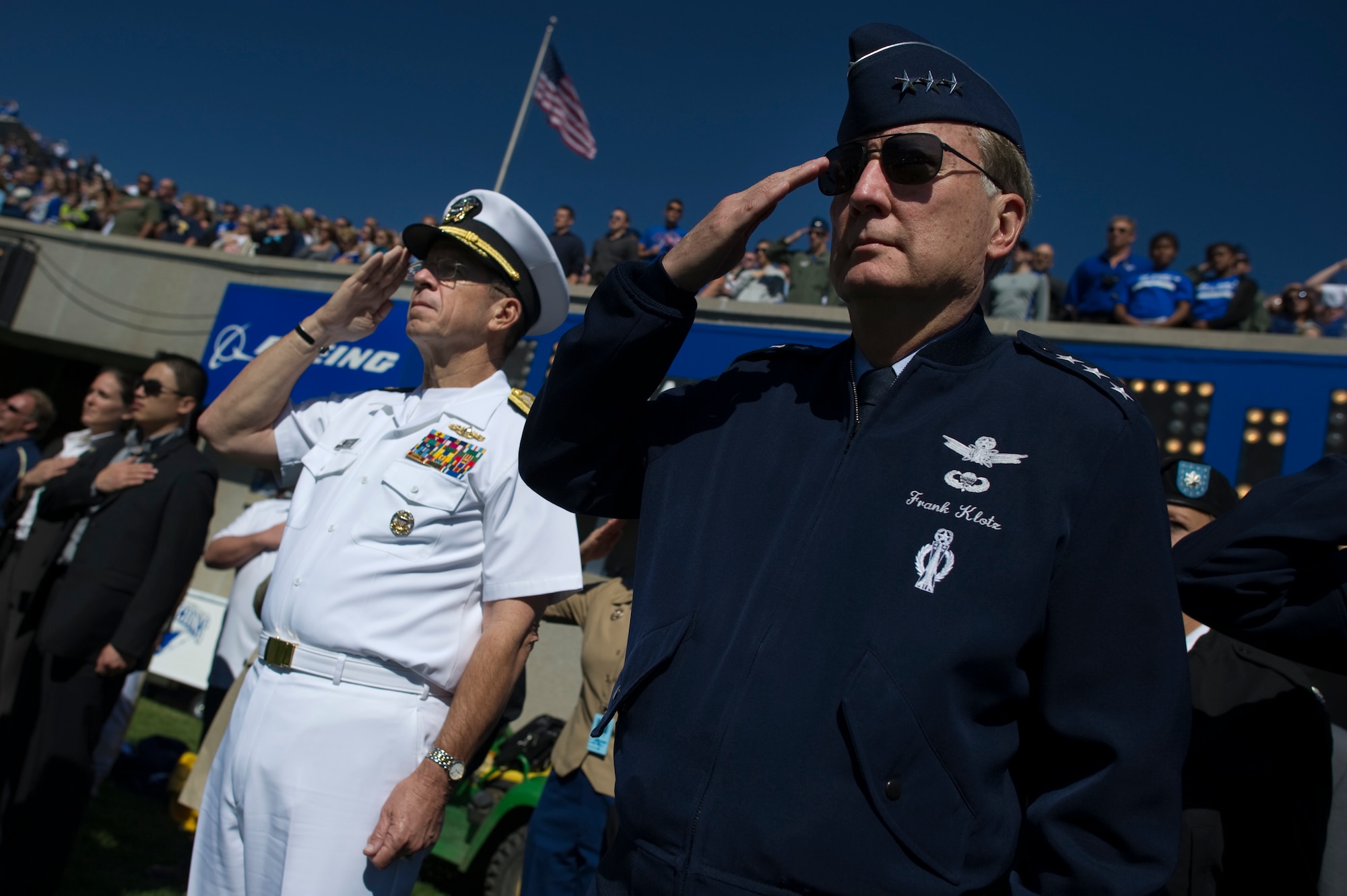 Chairman of the Joint Chiefs of Staff Navy Adm. Mike Mullen, left, and U.S. Air Force Lt. Gen. Frank Klotz, commander of Air Force Global Strike Command, salute as the national anthem is played before a football game between the U.S. Air Force Academy Falcons and the U.S. Naval Academy Midshipmen in Colorado Springs, Colo., Oct. 2 (Photo by Navy Petty Officer 1st Class Chad McNeeley)