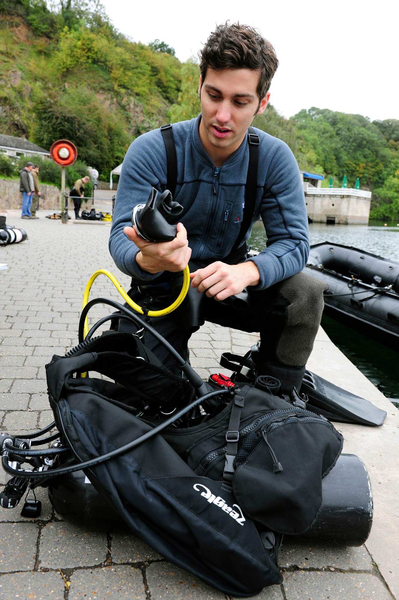 Senior Airman Eli Reynolds checks his equipment during subsurface search, rescue and recovery training Oct. 5, 2010, at Stoney Cove, England. The combined equipment of all the divers weighed between 1,500 and 1,800 lbs. Airman Reynolds is a 56th Rescue Squadron pararescueman. (U.S. Air Force photo/Airman 1st Class Lausanne Morgan) 