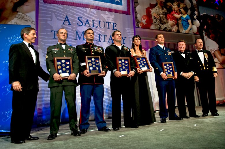 (From left to right) USO President Sloan Gibson; Army Sgt. Zachary C. Dispennette; Marine Corps Sgt. Eric B. Walker; Navy Petty Officer 2nd Class Kenton J. Stacy; Kimberly Watkins, mother of award recipient Staff Sgt. Gino P. Kahaunaele; Coast Guard Petty Officer 3rd Class Robert D. Emley; Edward T. Reilly, president of the USO board of governors; and Navy Adm. Mike Mullen, chairman of the Joint Chiefs of Staff, pose for photos at the USO Gala Oct. 7, 2010, in Washington, D.C.. (DOD photo/U.S. Navy Petty Officer 1st Class Chad J. McNeeley)