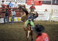MINOT, N.D. -- Scott Montague of Rapid City, S.D., holds on for 8 seconds scoring 82 points during the saddle bronc competition at the 2010 Y’s Men’s Rodeo here Oct. 7. The 56th annual Y’s Men’s Rodeo is being held at the North Dakota State Fairgrounds through Sunday, Oct. 10 with all proceeds from the rodeo benefiting the YMCA’s Triangle Y camp located near Garrison, N.D. Military appreciation day is Sunday, Oct. 10. All military members, family members and retirees receive half off of the ticket price with a military ID. Tickets may be purchased at the Dakota Square Mall ticket booth or at the North Dakota State Fair Center ticket booth. (U.S. Air Force photo by Staff Sgt. Keith Ballard)