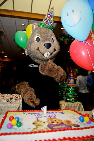 MINOT AIR FORCE BASE, N.D. -- Darby, the 5th Force Support Squadron mascot, poses with his cake during his birthday party at the community center here Oct. 7. Darby has served the Minot AFB community for more than 21 years. Other mascots who came to support Darby on his day of celebration included: McGruff the Crime Dog, Sparky the Fire Dog, Ready Freddy and Minot State’s Buckshot. (U.S. Air Force photo by Senior Airman Benjamin Stratton)