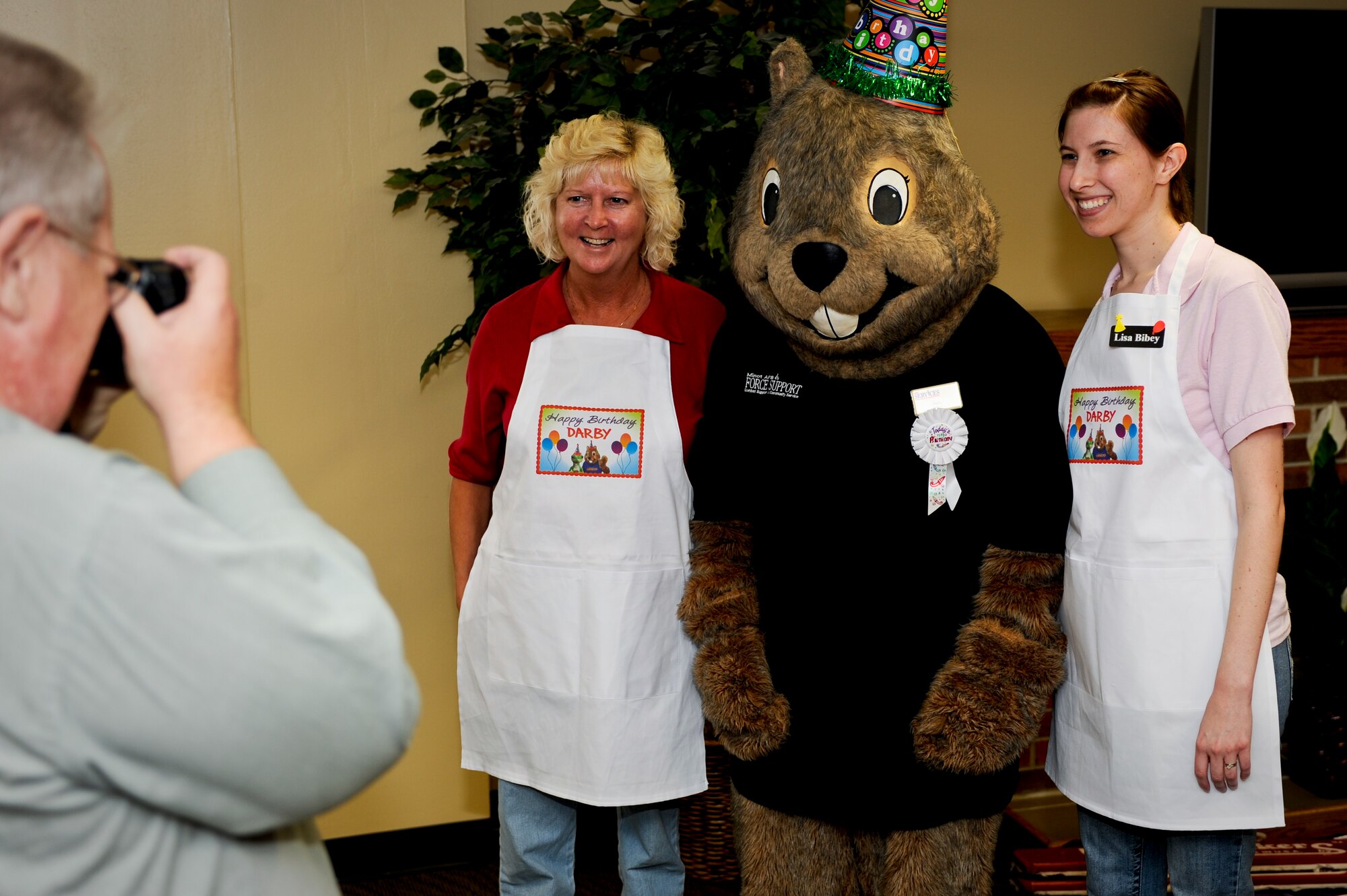 MINOT AIR FORCE BASE, N.D. -- Darby, the 5th Force Support Squadron mascot, gets his picture taken with volunteers during his birthday party at the community center here Oct. 7. Darby has served the Minot AFB community for more than 21 years. Other mascots who came to support Darby on his day of celebration included: McGruff the Crime Dog, Sparky the Fire Dog, Ready Freddy and Minot State’s Buckshot. (U.S. Air Force photo by Senior Airman Benjamin Stratton)