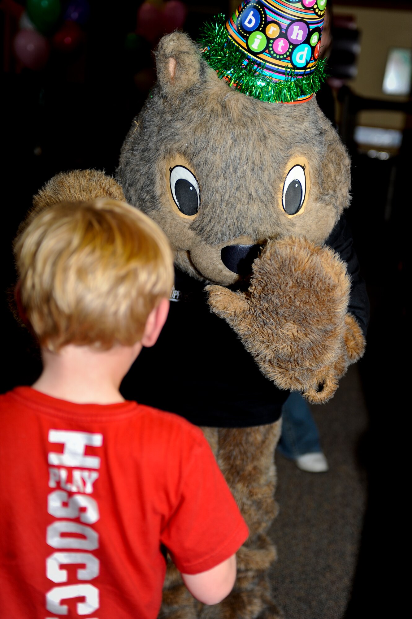 MINOT AIR FORCE BASE, N.D. -- Darby, the 5th Force Support Squadron mascot, gives a child a high-five during his birthday party at the community center here Oct. 7. Darby has served the Minot AFB community for more than 21 years. Other mascots who came to support Darby on his day of celebration included: McGruff the Crime Dog, Sparky the Fire Dog, Ready Freddy and Minot State’s Buckshot. (U.S. Air Force photo by Senior Airman Benjamin Stratton)