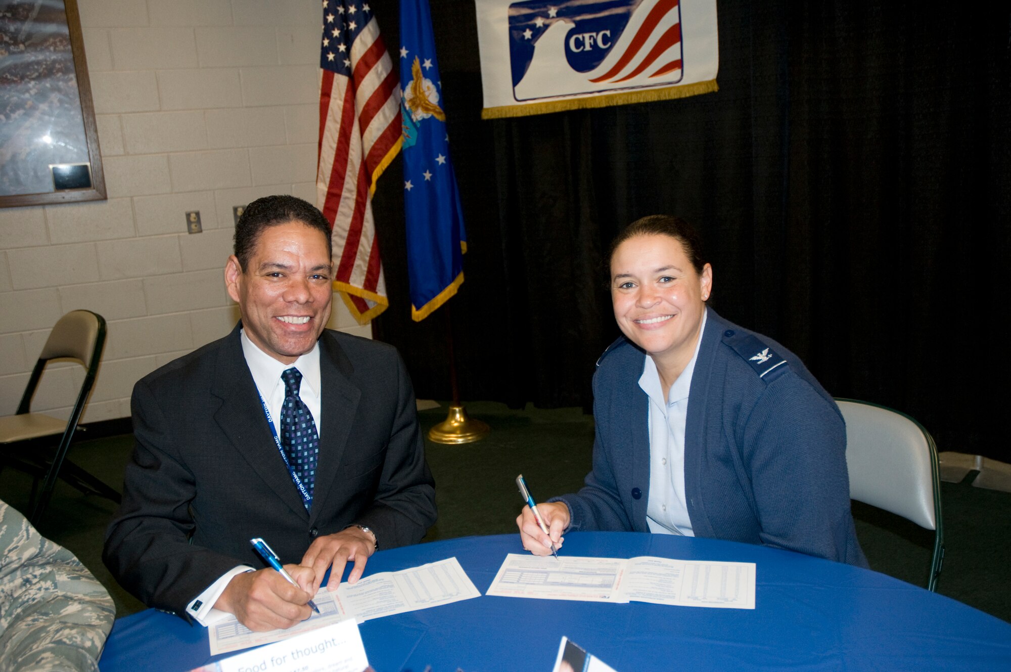 Guy Richardson and Col. Amanda Gladney make their pledges during the Miami Valley Combined Federal Campaign Kickoff Oct. 6, 2010 at the Nutter Center on the Wright State University campus.  Miami Valley CFC is the local campaign for DoD and Federal employees working in Champaign, Clark, Darke, Fayette, Greene, Miami, Montgomery, Preble, Shelby and Warren counties in Ohio to give to the charities of their choice. Mr. Richardson is Dayton Veterans Administration Medical Center director, and Colonel Gladney is 88th Air Base Wing commander at Wright-Patterson Air Force Base. (Skywrighter photo/Niki Jahns)