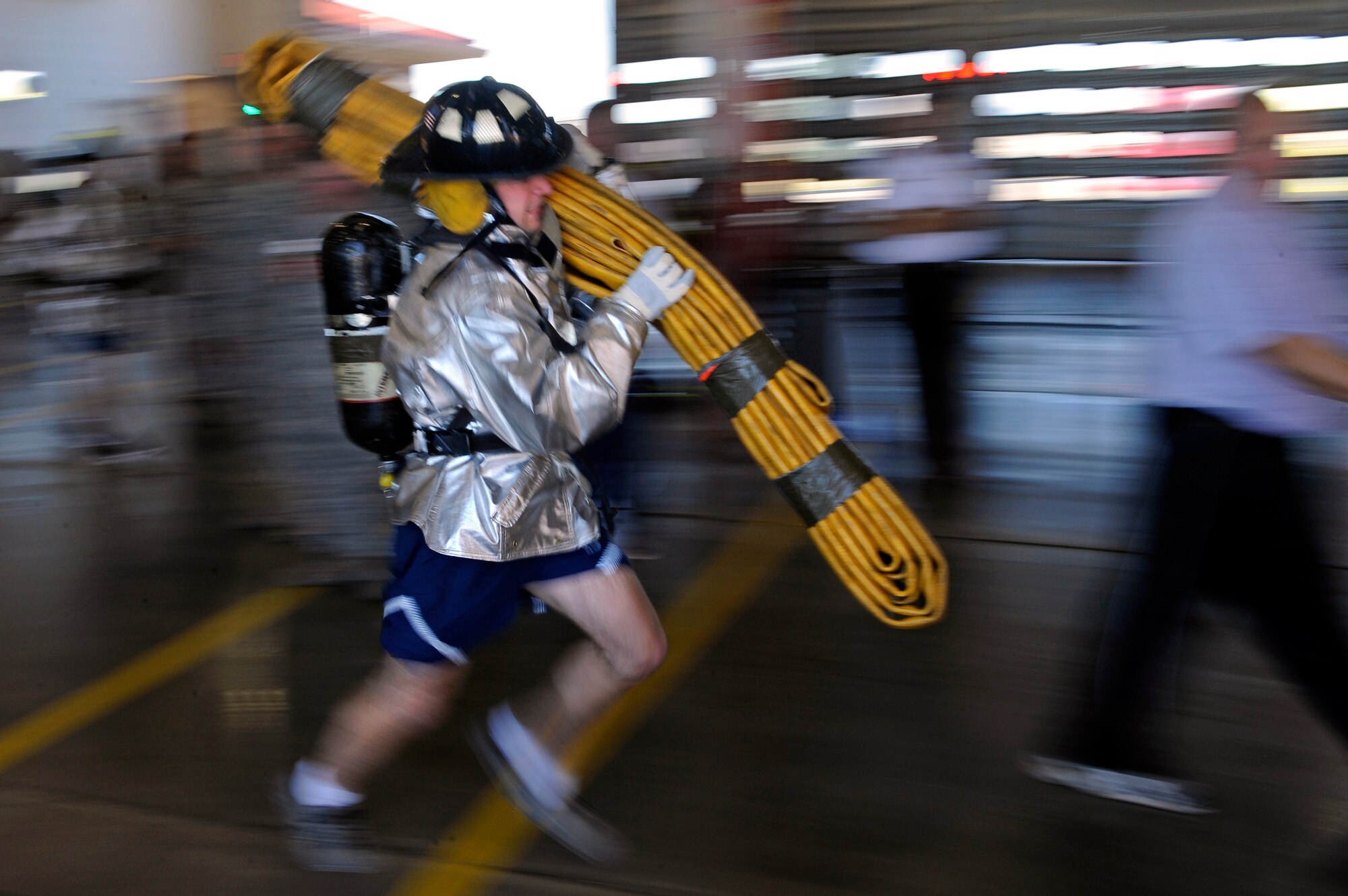 ELLSWORTH AFB, S.D. - Staff Sgt. Kory Peterson, 28th Civil Engineer Squadron pavement and construction equipment operator, runs with a hose during the 2010 Ellsworth Firefighter Challenge, Oct. 1.  Airmen from ten agencies at Ellsworth formed teams to participate in the challenge. (U.S. Air Force photo/Staff Sgt. Marc I. Lane)