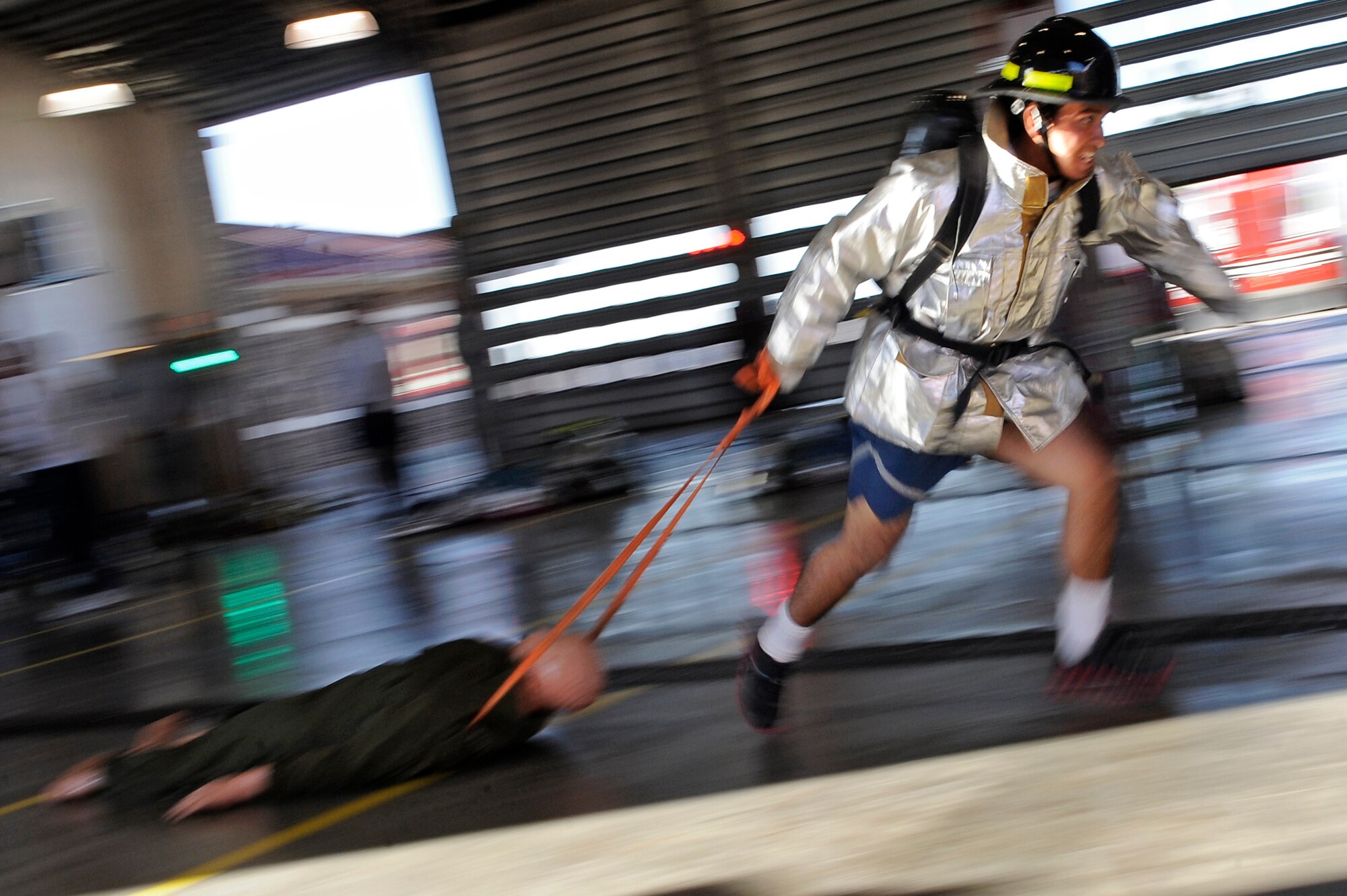 ELLSWORTH AFB, S.D. - Airman 1st Class Allan Rosales, 28th Civil Engineer Squadron electrician, carries a hose up a flight of stairs during the 2010 Ellsworth Firefighter Challenge, Oct. 1.  Airman Rosales and his team from the 28th CES electric shop won the competition with a time of 3:56. (U.S. Air Force photo/Staff Sgt. Marc I. Lane)