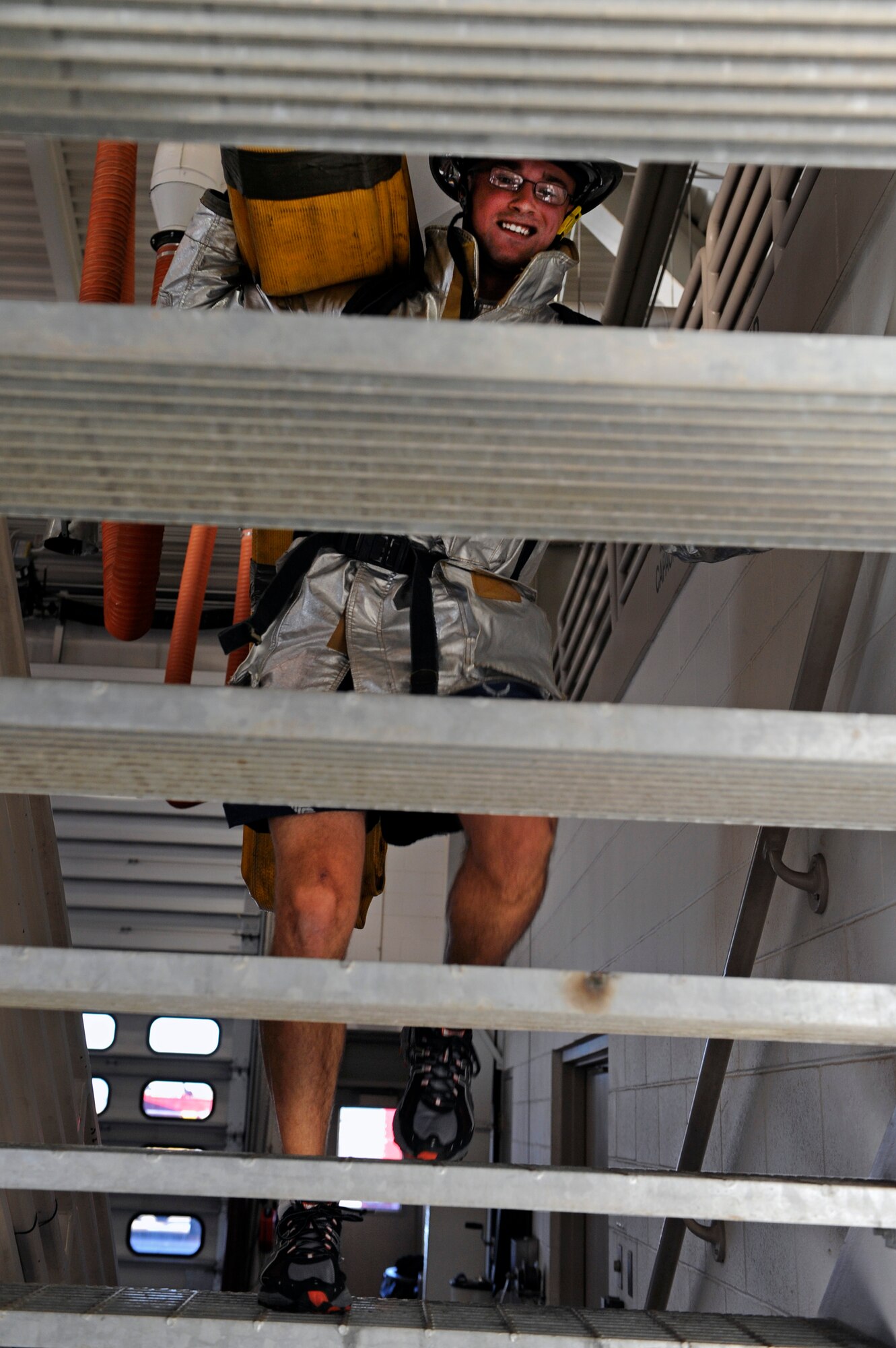 ELLSWORTH AFB, S.D. - Senior Airman Alex Luebrecht, 28th Civil Engineer Squadron engineer, carries a hose up a flight of stairs during the 2010 Ellsworth Firefighter Challenge, Oct. 1.  The competition helped lead the base into Fire Prevention Week, Oct 3 - 9. (U.S. Air Force photo/Staff Sgt. Marc I. Lane)