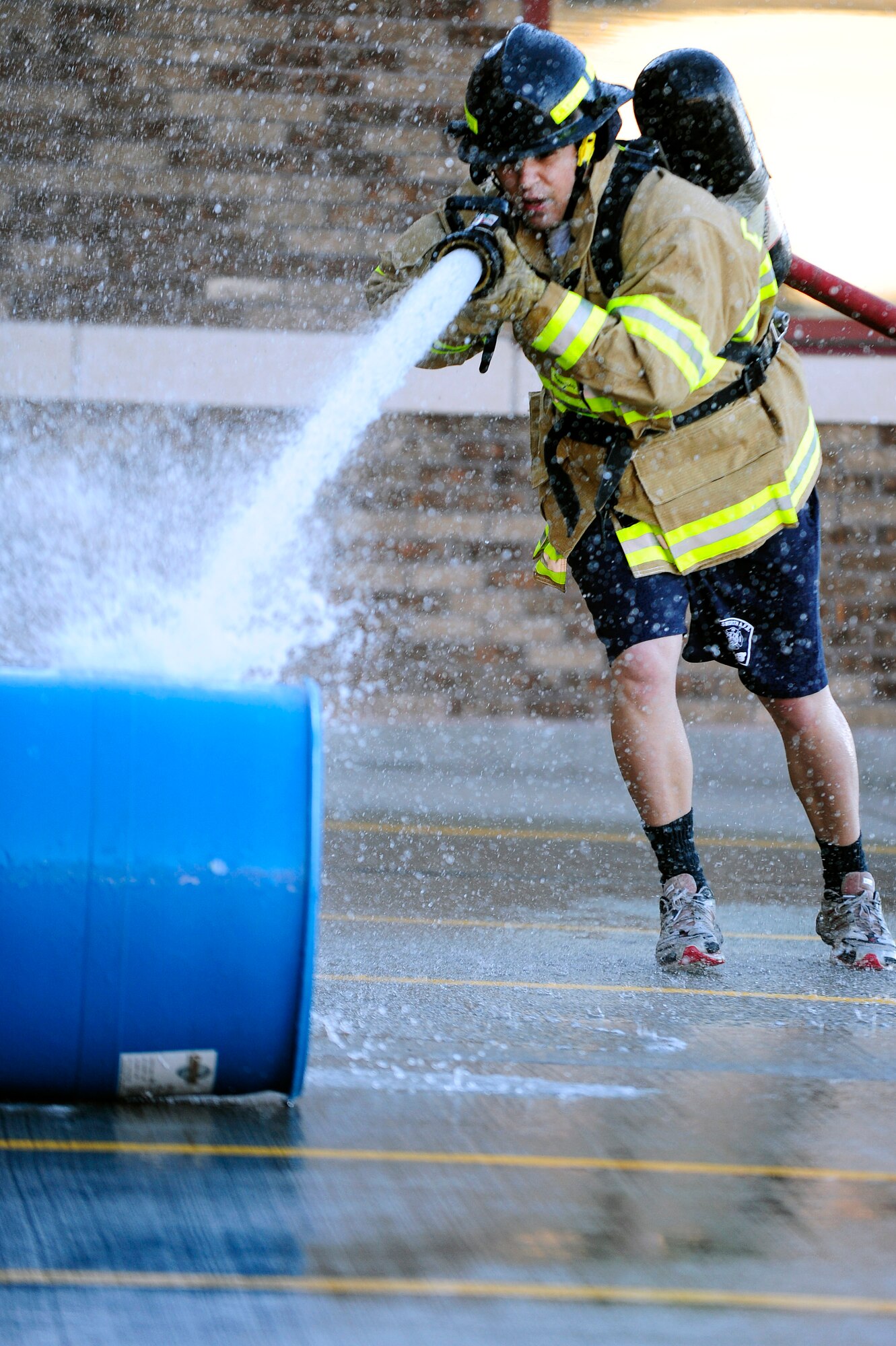 ELLSWORTH AFB, S.D. - Senior Airman Irvin Vasquez, 28th Civil Engineer Squadron firefighter, sprays a barrel during the 2010 Ellsworth Firefighter Challenge, Oct. 1.  The competition helped lead the base into Fire Prevention Week, Oct 3 - 9.  The message of this year’s Fire Prevention Week is: “Smoke Detectors, a sound you can live with.” (U.S. Air Force photo/Staff Sgt. Marc I. Lane)