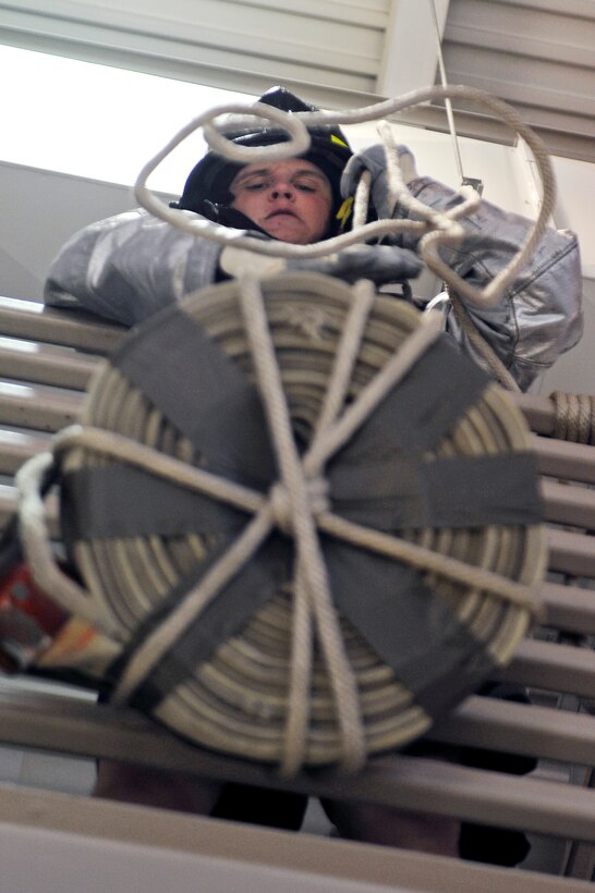 ELLSWORTH AFB, S.D. -Airman 1st Class Bryan Dodson, 28th Civil Engineer Squadron water/fuels systems maintainer, drags a dummy during the 2010 Ellsworth Firefighter Challenge, Oct. 1.  The competition was a timed event consisting of a hose drag and barrel spray, dummy drag, hose carry, hose hoist, ladder climb, and a weighted sled hammering. (U.S. Air Force photo/Staff Sgt. Marc I. Lane)
