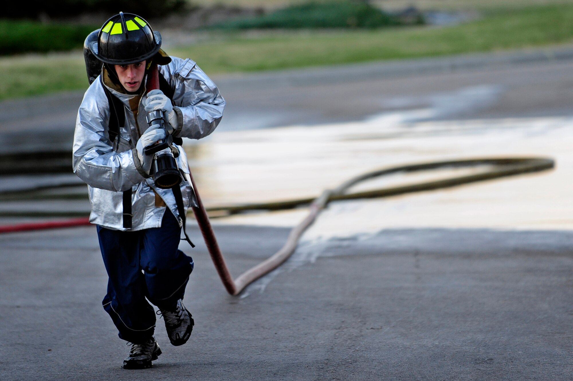 ELLSWORTH AFB, S.D. -Airman Joseph Leitz, 28th Security Forces Squadron member, drags a hose while participating in the 2010 Ellsworth Firefighter Challenge, Oct. 1.  The competition was a timed event consisting of a hose drag and barrel spray, dummy drag, hose carry, hose hoist, ladder climb and a weighted sled hammering. (U.S. Air Force photo/Staff Sgt. Marc I. Lane)