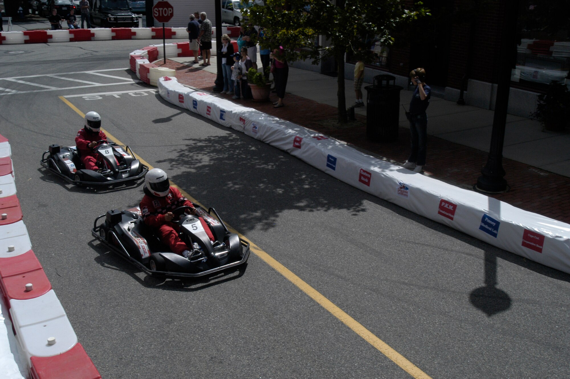 Col. Anthony E. Schiavi, 102nd Intelligence Wing commander, maintains good position with go-kart number five in order to keep go-kart number eight from passing during the 10th annual Seaside LeMans, Sept. 11, at Mashpee Commons, Mass.  Seaside LeMans is known as 'The race for the Cape Cod community' and has raised more than $2.8 million since it began in 2001.  All proceeds of the event are donated to The Cape Cod Foundation, which distributes 100 percent of each year's funds to the designated beneficiaries for that year.  
(U.S. Air Force photo by Maj. Nicole Ivers)
