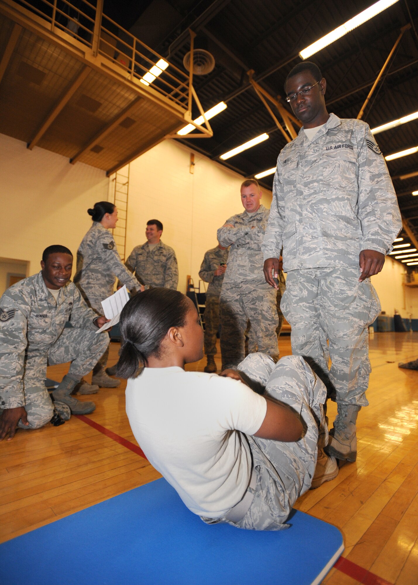 Staff Sgt. Sandra Williams, 27th Special Operations Equipment Maintenance Squadron, races to reach 200 sit ups in 10 minutes during the Chief's Challenge Oct. 8 at the base gym. Sergeant Williams finished with 192 sit ups, just missing her goal. (U.S. Air Force photo by Senior Airman Maynelinne De La Cruz)