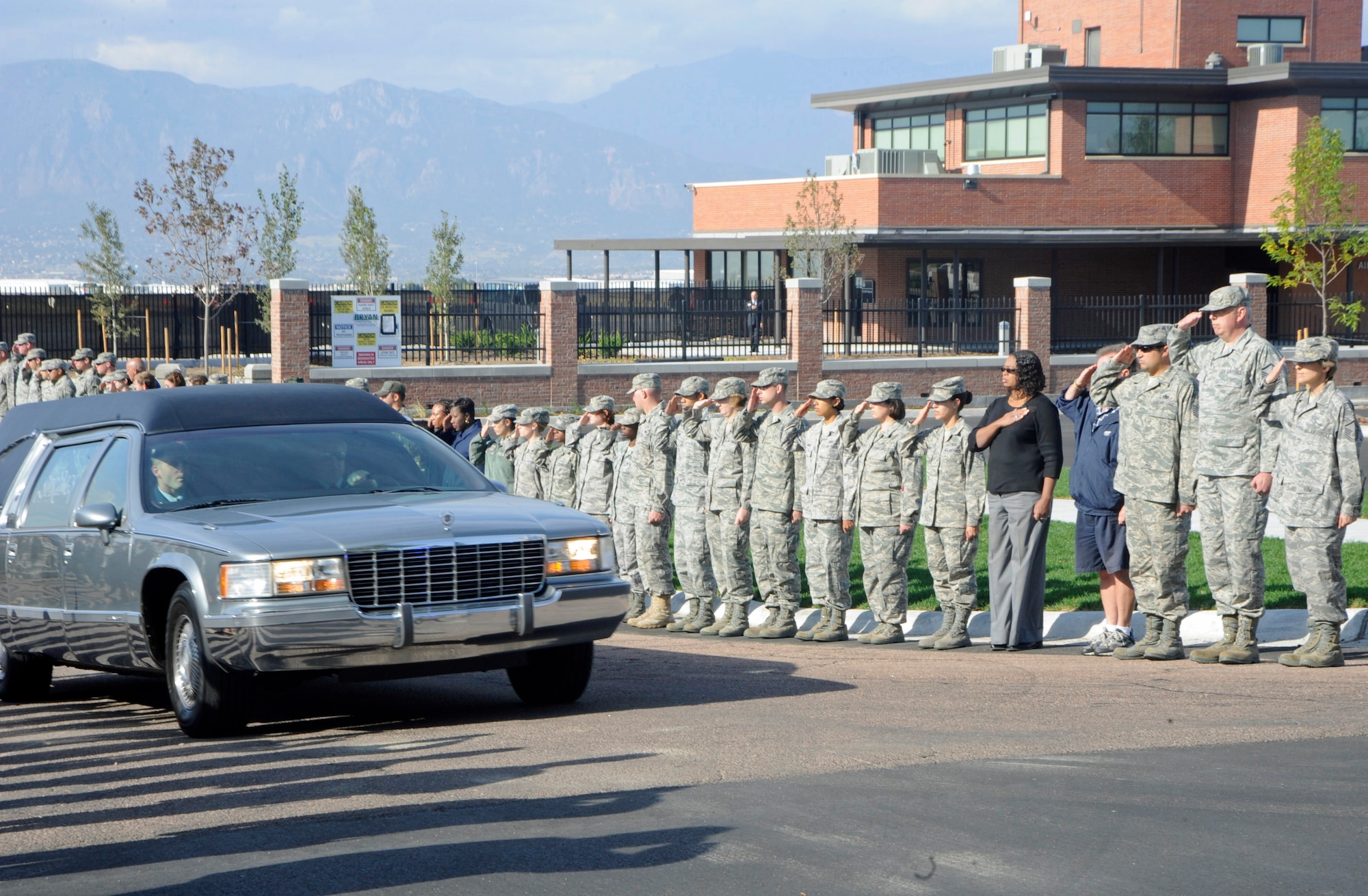 Servicemembers from all branches lined Peterson Boulevard Oct. 6 to pay their respects to a fallen Soldier returning to Colorado Springs. Hundreds of members from Team Pete lined the road as the procession passed, honoring the Soldier -- who was killed while supporting Operation Enduring Freedom -- and his family. (U.S. Air Force photo/Dennis Howk)