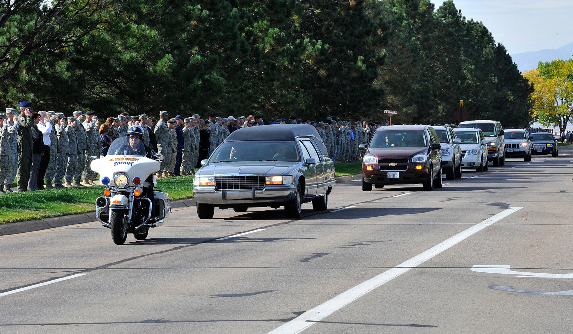 Servicemembers from all branches lined Peterson Boulevard Oct. 6 to pay their respects to a fallen Soldier returning to Colorado Springs. Hundreds of members from Team Pete lined the road as the procession passed, honoring the Soldier -- who was killed while supporting Operation Enduring Freedom -- and his family. (U.S. Air Force photo/Rob Bussard)