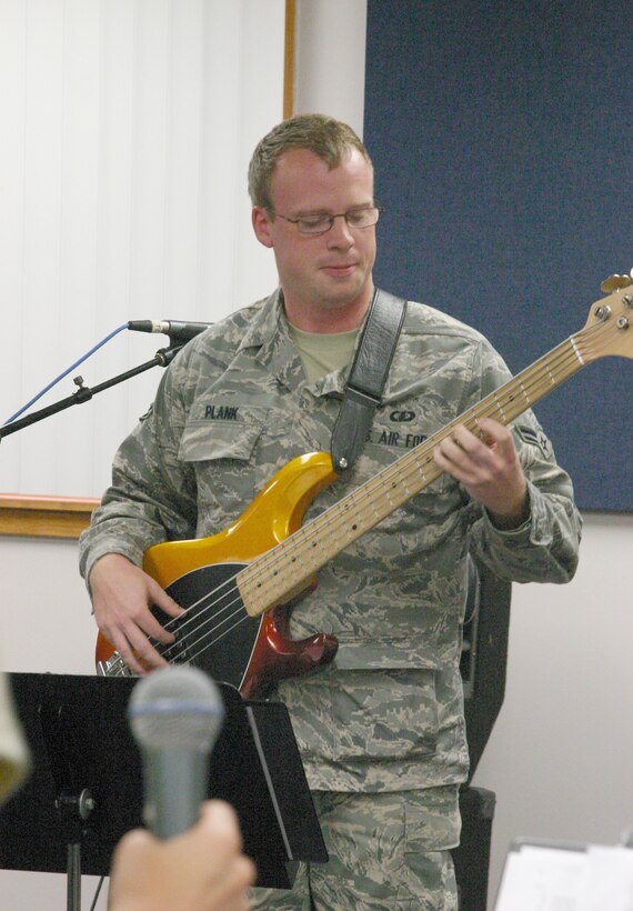 A1C Brian Plank digs into his bass guitar during Starlifter’s morning rehearsal