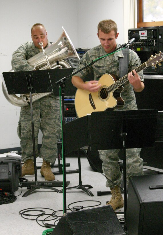 A1C Aaron Kusterer, Hot Brass’ newest guitarist, intensely reads his music as SSgt Matt Kuebler does the same on Tuba