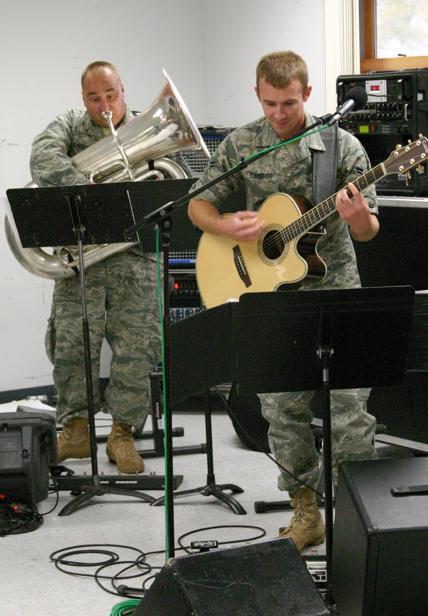 A1C Aaron Kusterer, Hot Brass’ newest guitarist, intensely reads his music as SSgt Matt Kuebler does the same on Tuba