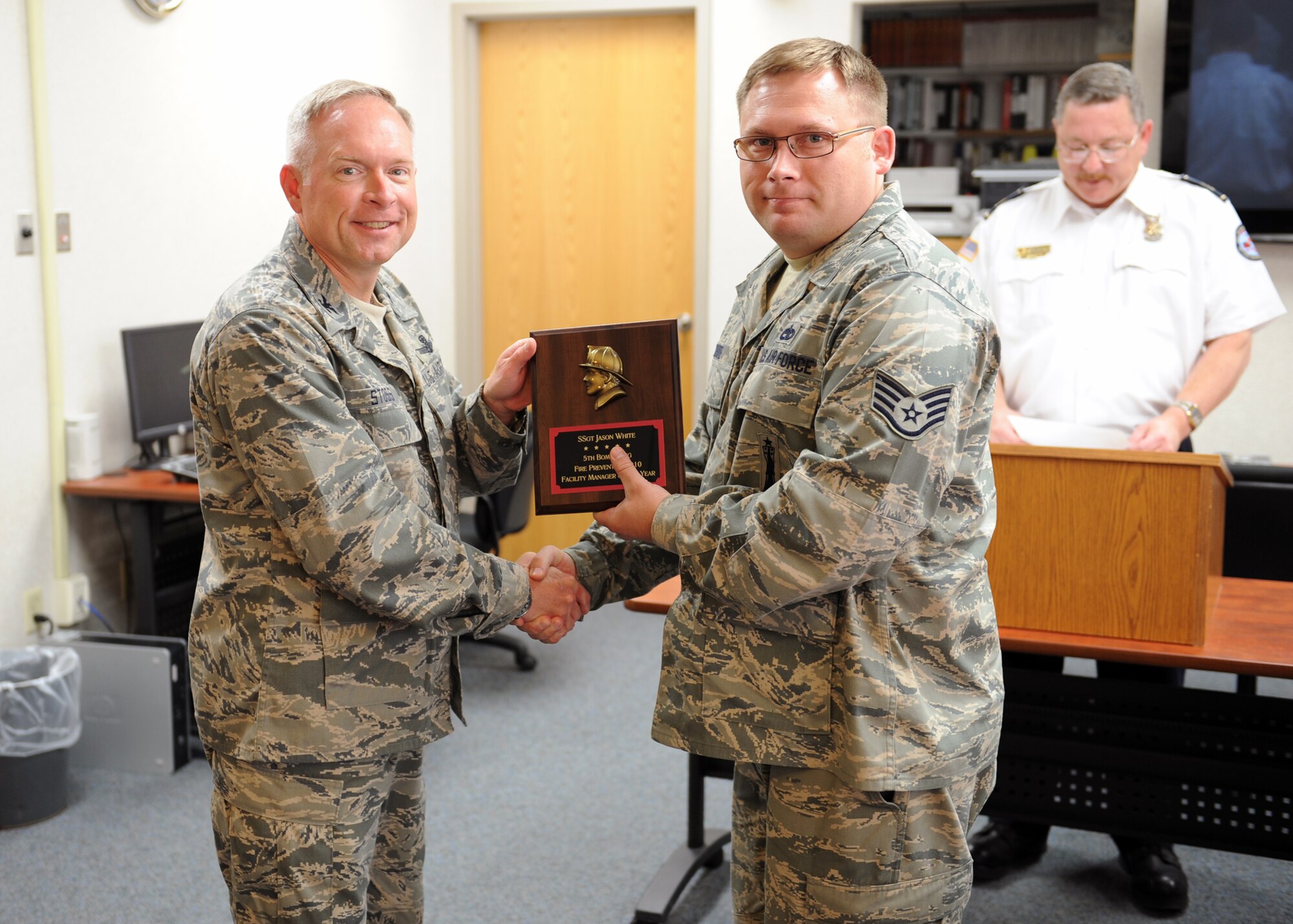 MINOT AIR FORCE BASE, N.D. -- Staff Sgt. Jason White, 5th Civil Engineer Squadron facility manager, is presented the 5th Bomb Wing’s 2010 Fire Prevention Facility Manager of the Year award by Col. Fred Stoss, 91st Missile Wing commander, here Oct. 7. Sergeant White oversees 17 dormitories on base, fixing all deficiencies and ensuring all Air Force Global Strike Command’s newest airmen are safe and secure. (U.S. Air Force photo by Staff Sgt. Keith Ballard)