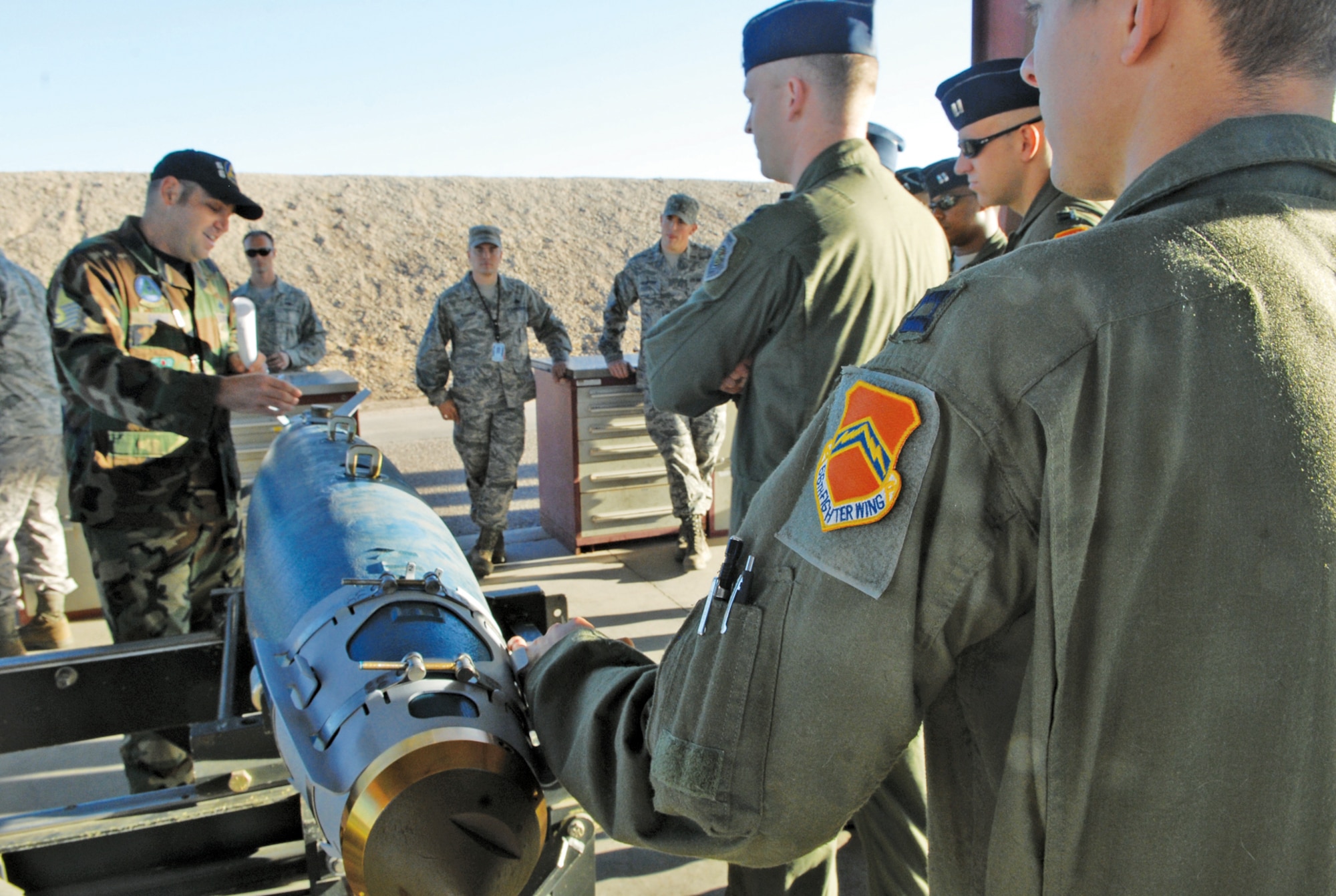 Master Sgt. Jeffrey Baker, 56th Equipment Maintenance Squadron conventional maintenance NCO-in-charge, briefs a group of student pilots on assembly of a GBU-38 inert bomb during a routine bomb build at the munitions storage area, Luke Air Force Base, Arizona.  (U.S. Air Force photo/Senior Master Sgt. Larry Schneck)