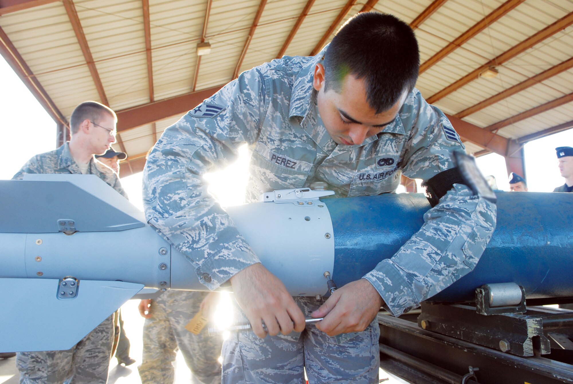 Senior Airman Paul Perez, 56th Equipment Maintenance Squadron bomb crew crewmember, works on assembly of a GBU-38 inert bomb.  (U.S. Air Force photo/Senior Master Sgt. Larry Schneck)