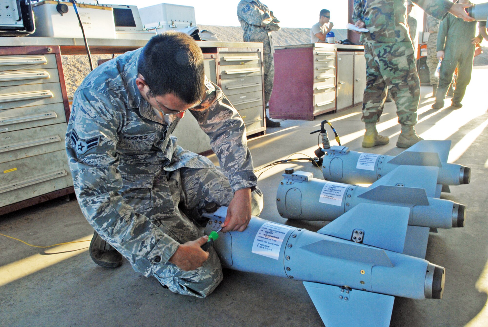 Airman 1st Class Robert Hughes, 56th Equipment Maintenance Squadron bomb crew crewmember, works on the tail assembly of a GBU-38 inert bomb.  (U.S. Air Force photo/Senior Master Sgt. Larry Schneck)