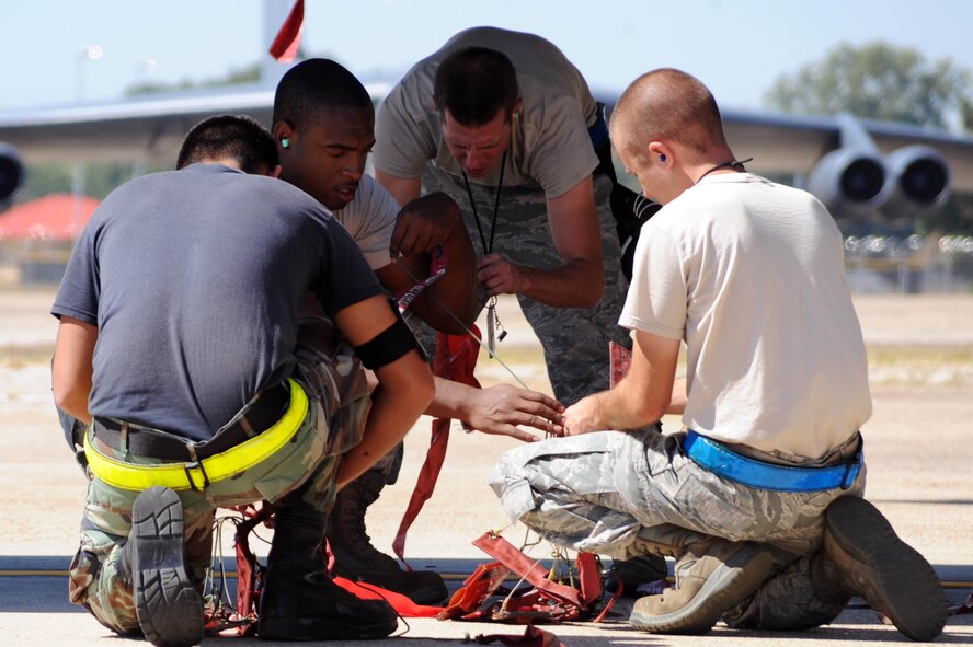 BARKSDALE AIR FORCE BASE, La. -- Airmen from the 2nd Aircraft Maintenance Squadron, weapons load crew, untangle safely 'remove before flight' streamers before attaching them to a B-52H Stratofortress during a nuclear operational readiness exercise, here Oct. 7. During a NORE Barksdale Airmen undergo scenarios in coordination with the U.S. Strategic Command directives. (U.S. Air Force photo/Senior Airman Brittany Y. Bateman)(RELEASED)