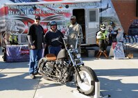 MINOT AIR FORCE BASE, N.D. -- A motorcycle merchant, who is very supportive of the U.S. military, came to the Base Exchange in an effort to meet the men and women of Minot AFB and to showcase some of their products here Oct. 6. James Campbell, the company’s chief executive officer, Rodney Krause, 5th Bomb Wing safety and occupational health manager, and Tech. Sgt. Donald Thomas, 2nd Maintenance Squadron aerospace ground equipment journeyman currently deployed to Minot AFB from Barksdale AFB, La., stand with one of the motorcycles on display. The visiting merchant is a motorcycle parts company that only sells products to military members and their families. According to James Campbell, the company’s chief executive officer, “There were no companies out there who catered to military members and their unique needs, because of their commitment to the military. As a former military member, I know firsthand how difficult it can be to try to buy motorcycle parts from wherever you are stationed in the world and I wanted to start a business that helps the individual with whatever his or her needs are.”  (U.S. Air Force photo by Staff Sgt. Keith Ballard)